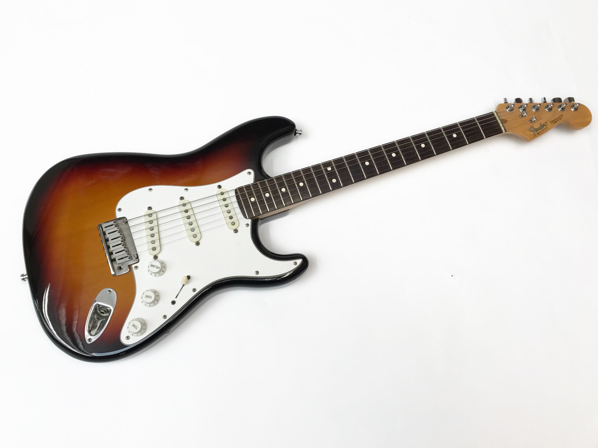 Electric guitar with a sunburst finish on a white background